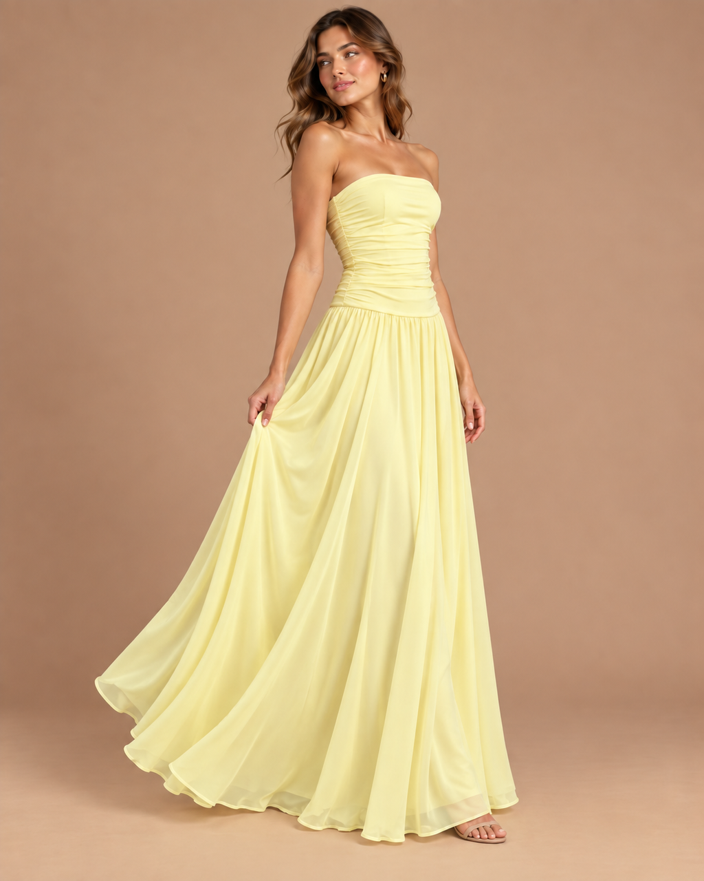 Strapless Ruched Drop Waist Maxi Dress in Butter Yellow, on model, holding out the skirt