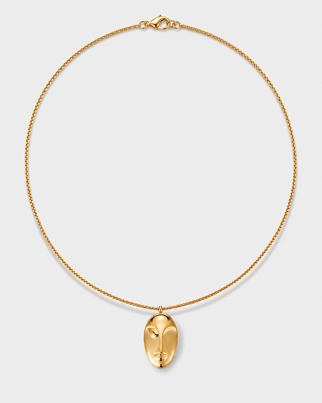 Gold Pendant Necklace with a sculpted face pendant