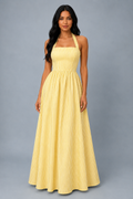 Model wearing the yellow pinstripe halter maxi dress, front view