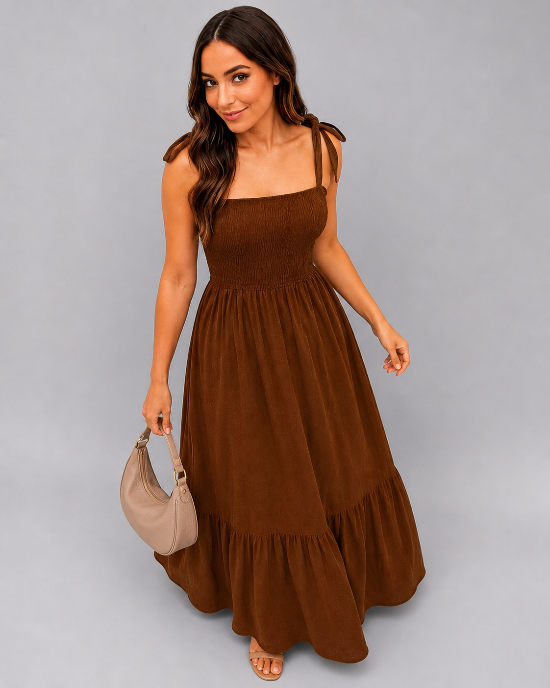 Model wearing the Chestnut Shirred Tie-Strap Tiered Maxi Dress, styled with a shoulder bag